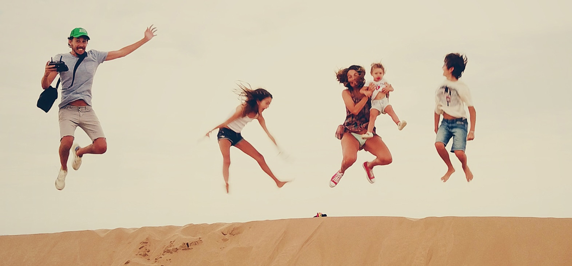 Family enjoying the dunes in the merzouga desert during their Morocco vacation