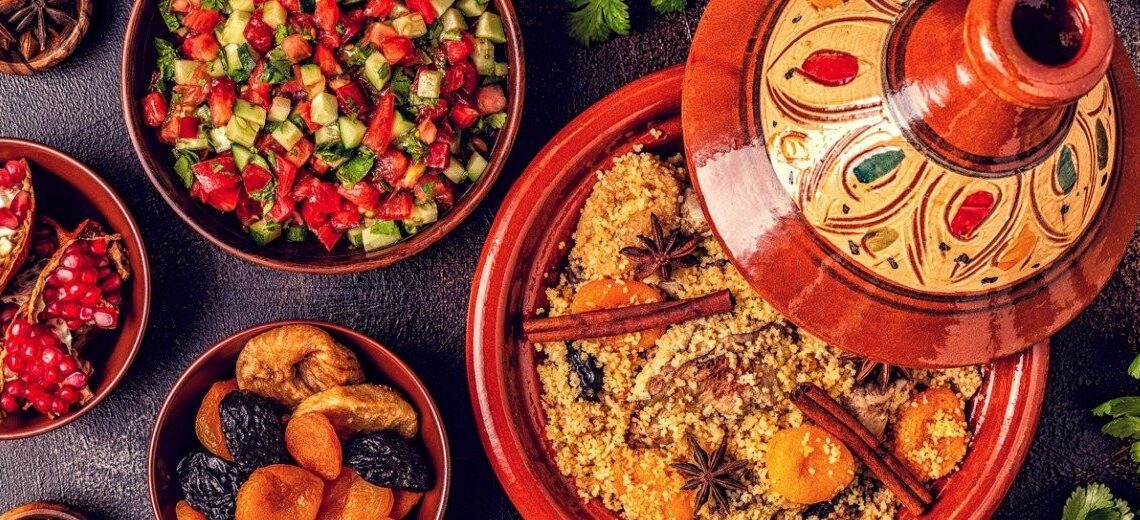 Image showcasing a variety of tagines, colorful Moroccan salads, and assorted fruits.